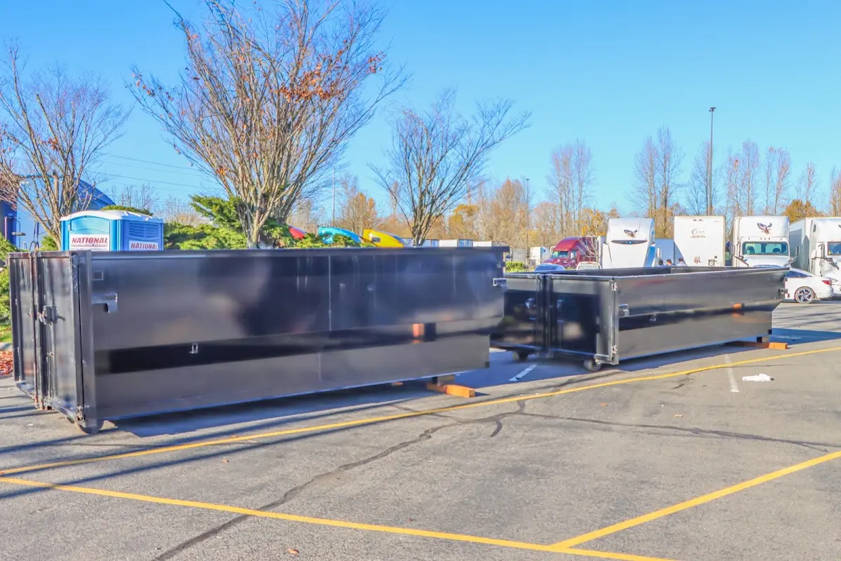 Professional dumpster rental service with roll-off container on residential driveway in Boxborough